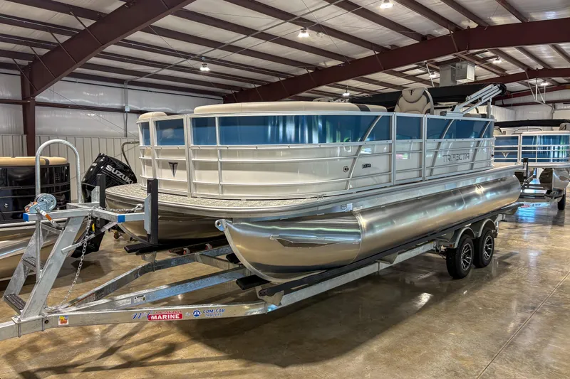 Slide: The Image of 2025 Trifecta 20RF LE pontoon boat on trailer in indoor showroom. - 1