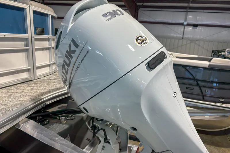 Slide: The Image of 2025 Trifecta 20RF LE with Suzuki 90 horsepower outboard motor in a showroom. - 4