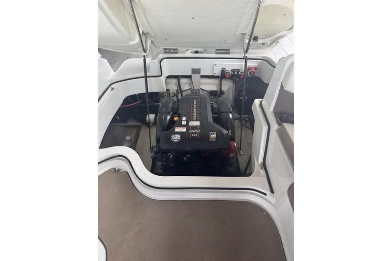 Slide: The Image of Interior of 2012 Cobalt 242 WSS boat with white seating and dark flooring. - 10