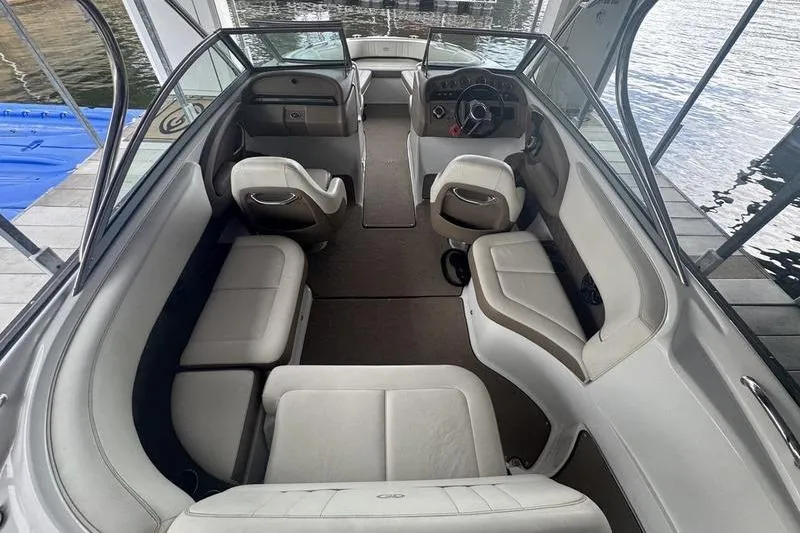 The Image of 2012 Cobalt 242 WSS boat with red canopy on trailer in showroom. - 3