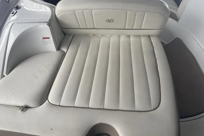 Slide: The Image of 2012 Cobalt 242 WSS boat displayed indoors with red canopy and trailer. - 5