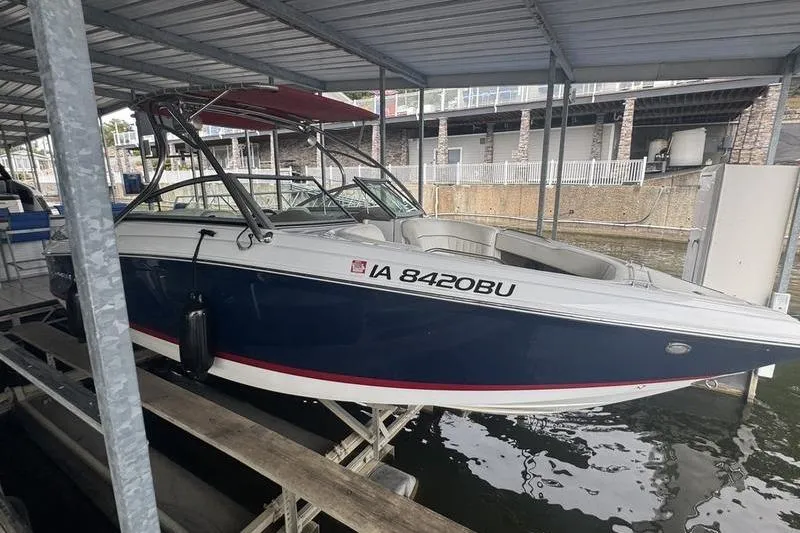 Slide: The Image of 2012 Cobalt 242 WSS boat displayed in showroom, featuring sleek design and spacious seating. - 7