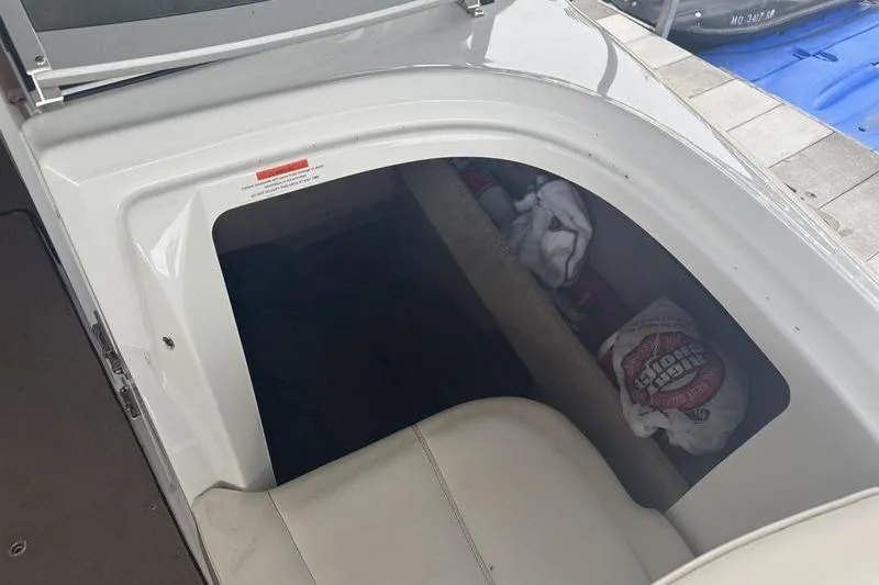 Slide: The Image of 2012 Cobalt 242 WSS boat interior with white seating and modern design. - 8