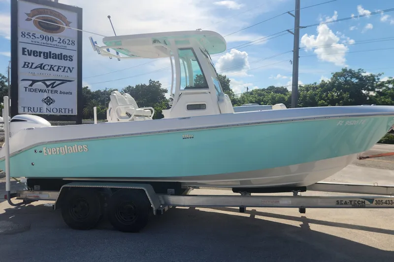 The Image of 2022 Everglades 235 Center Console boat on trailer, displayed outdoors under a clear sky. - 1