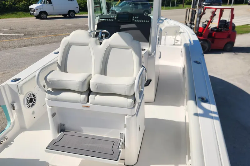 Slide: The Image of 2022 Everglades 235 Center Console boat interior with dual seats and steering console. - 10