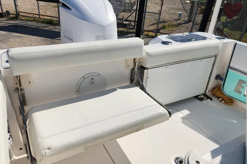 Slide: The Image of 2022 Everglades 235 Center Console boat interior with foldable seating and Yamaha engine. - 11