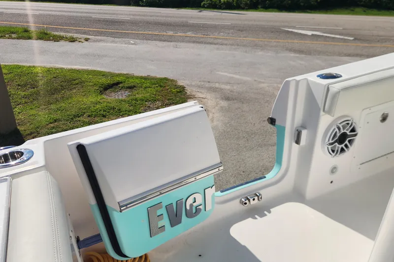 Slide: The Image of 2022 Everglades 235 Center Console boat interior with open door and speaker. - 12