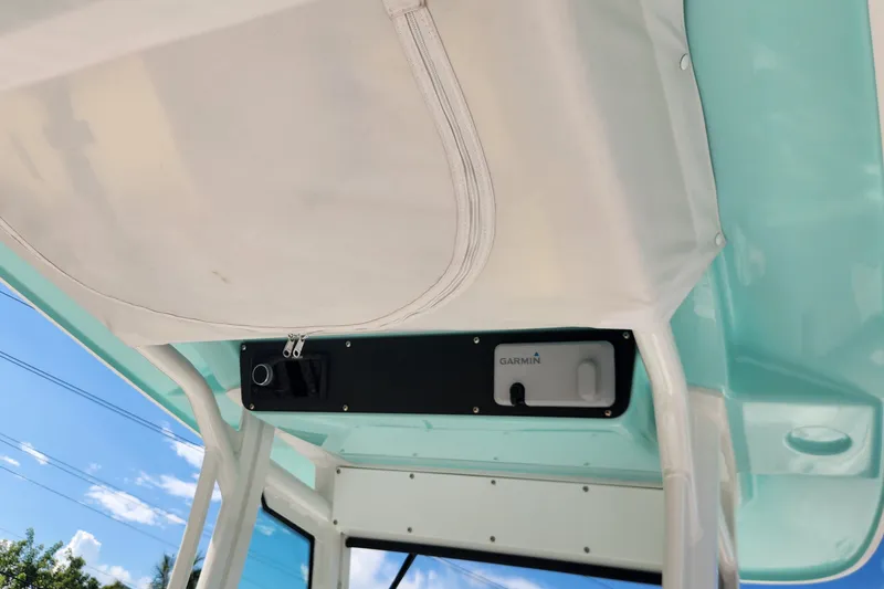 Slide: The Image of 2022 Everglades 235 Center Console boat with Garmin equipment under canopy. - 16