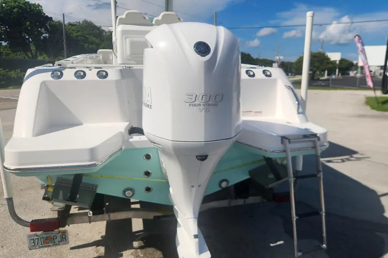 Slide: The Image of 2022 Everglades 235 Center Console boat with Yamaha 300 V6 engine, parked outdoors. - 7