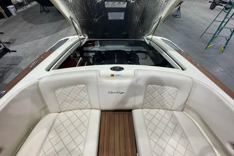 Slide: The Image of 2021 Chris-Craft Launch 23 boat interior with open engine compartment and luxurious seating. - 10