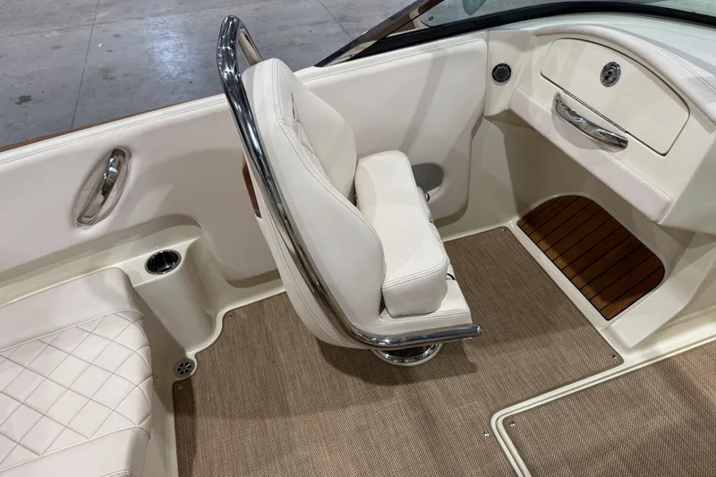 Slide: The Image of 2021 Chris-Craft Launch 23 interior with white seating and elegant wood accents. - 15