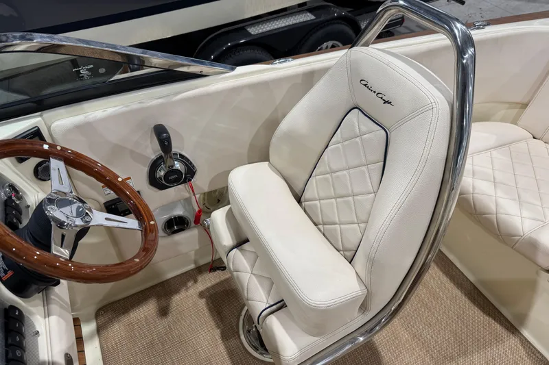 Slide: The Image of 2021 Chris-Craft Launch 23 interior with elegant steering wheel and luxurious seating. - 16