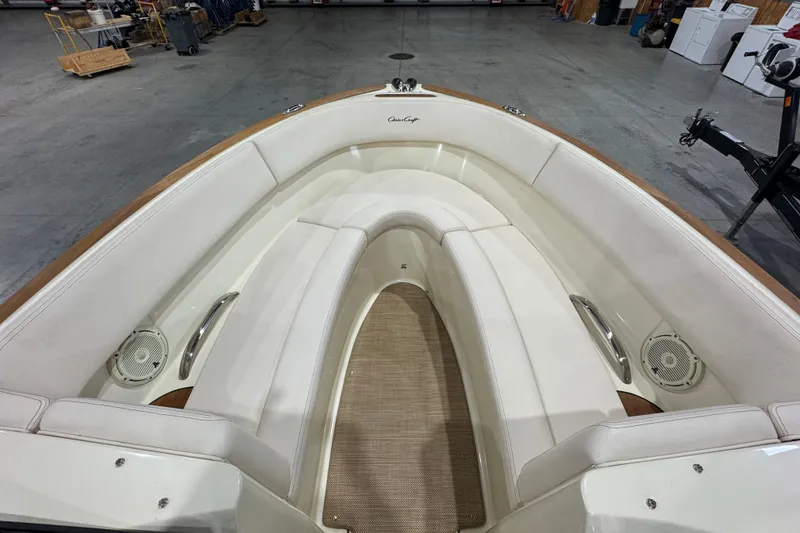 Slide: The Image of 2021 Chris-Craft Launch 23 boat interior with white seating and wood accents. - 17
