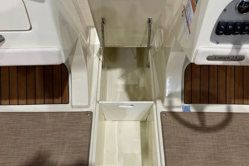 Slide: The Image of 2021 Chris-Craft Launch 23 interior with teak flooring and control panel. - 18