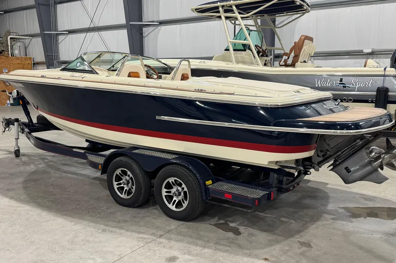 Slide: The Image of 2021 Chris-Craft Launch 23 boat on trailer in indoor storage facility. - 2