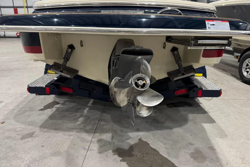 Slide: The Image of 2021 Chris-Craft Launch 23 boat stern with propeller in a garage setting. - 20