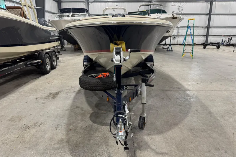 Slide: The Image of 2021 Chris-Craft Launch 23 boat on trailer in indoor storage facility. - 21