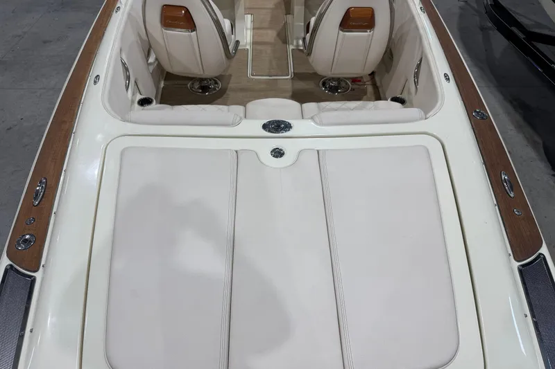 Slide: The Image of 2021 Chris-Craft Launch 23 boat interior with white leather seats and wooden accents. - 6