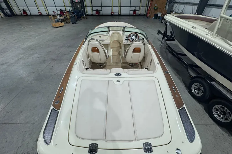 Slide: The Image of 2021 Chris-Craft Launch 23 boat in a spacious indoor storage facility. - 7