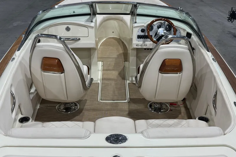 Slide: The Image of 2021 Chris-Craft Launch 23 boat interior with elegant seating and classic steering wheel design. - 8