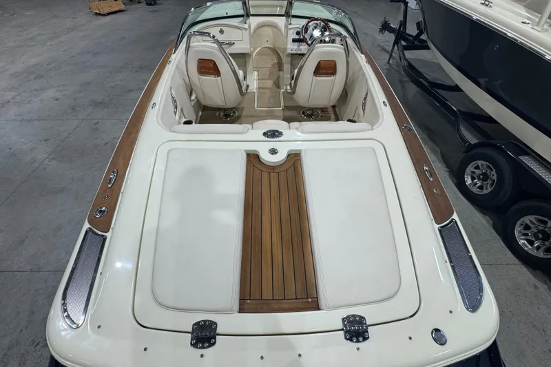 Slide: The Image of 2021 Chris-Craft Launch 23 boat interior with wood accents and sleek design. - 9