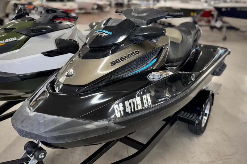 The Image of 2016 Sea-Doo GTX 155 jet ski on trailer, displayed indoors. - 0