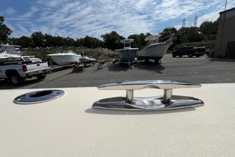 Slide: The Image of 2025 Jones Brothers 23 Cape Fisherman Lite Tackle boat in a marina with other boats. - 11