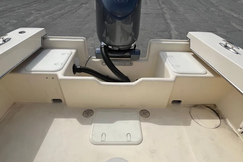 Slide: The Image of 2025 Jones Brothers 23 Cape Fisherman Lite Tackle boat interior with motor and storage compartments. - 18