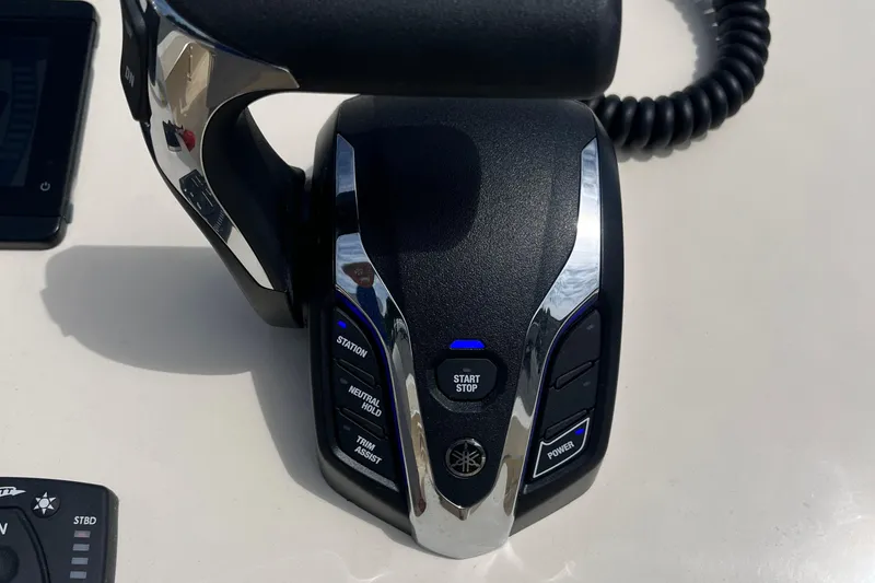 Slide: The Image of Close-up of a 2025 Jones Brothers 23 Cape Fisherman Lite Tackle boat control panel. - 8