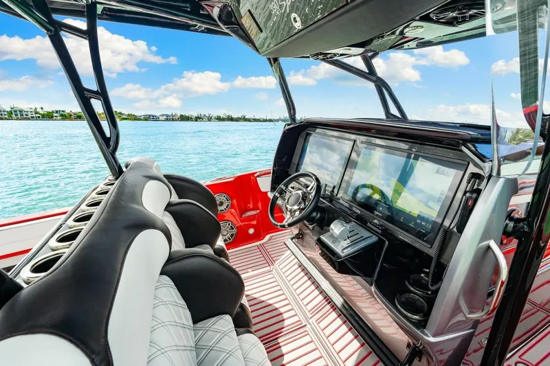 Slide: The Image of Interior of 2022 Nor-Tech 390 SS boat with modern dashboard and luxurious seating. - 15