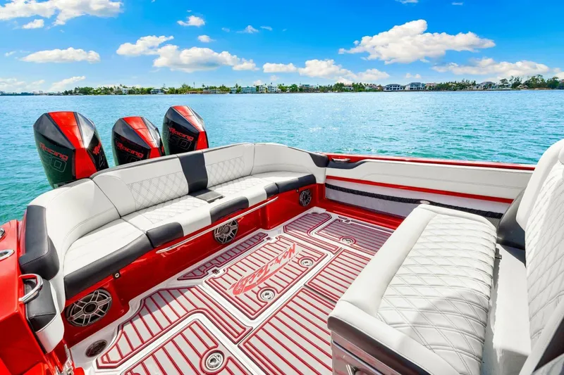 Slide: The Image of 2022 Nor-Tech 390 SS boat interior with luxurious seating and triple outboard engines. - 20
