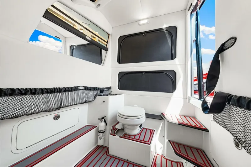 Slide: The Image of Interior of 2022 Nor-Tech 390 SS boat featuring a compact bathroom with modern amenities. - 47