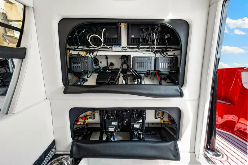 Slide: The Image of 2022 Nor-Tech 390 SS boat electrical panel with organized wiring and components. - 48