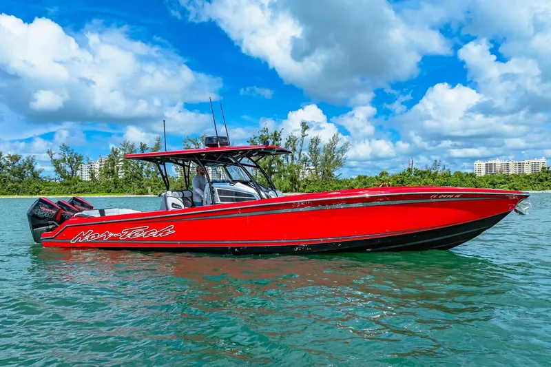 Slide: The Image of Red 2022 Nor-Tech 390 SS boat on water under blue sky. - 51