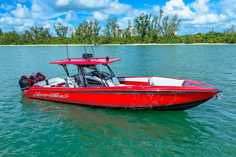 Slide: The Image of Red 2022 Nor-Tech 390 SS boat on water, featuring triple outboard engines. - 52