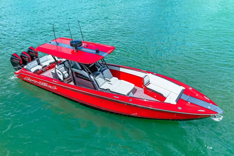 Slide: The Image of 2022 Nor-Tech 390 SS boat in vibrant red on clear blue water. - 53