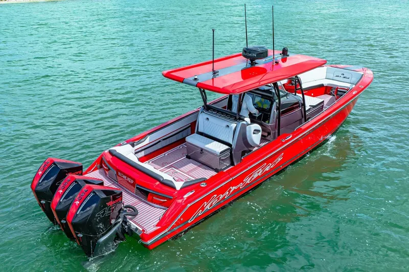 Slide: The Image of 2022 Nor-Tech 390 SS boat in vibrant red on clear water. - 56