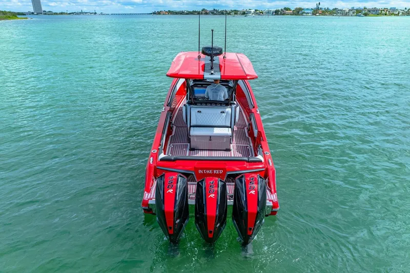 Slide: The Image of Red 2022 Nor-Tech 390 SS boat with triple 450R engines on open water. - 59