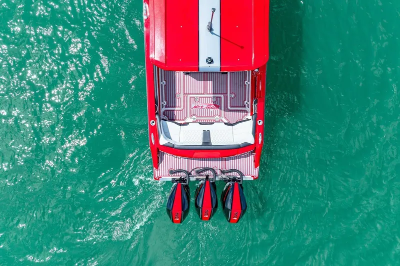 Slide: The Image of Overhead view of a 2022 Nor-Tech 390 SS boat on turquoise water. - 60