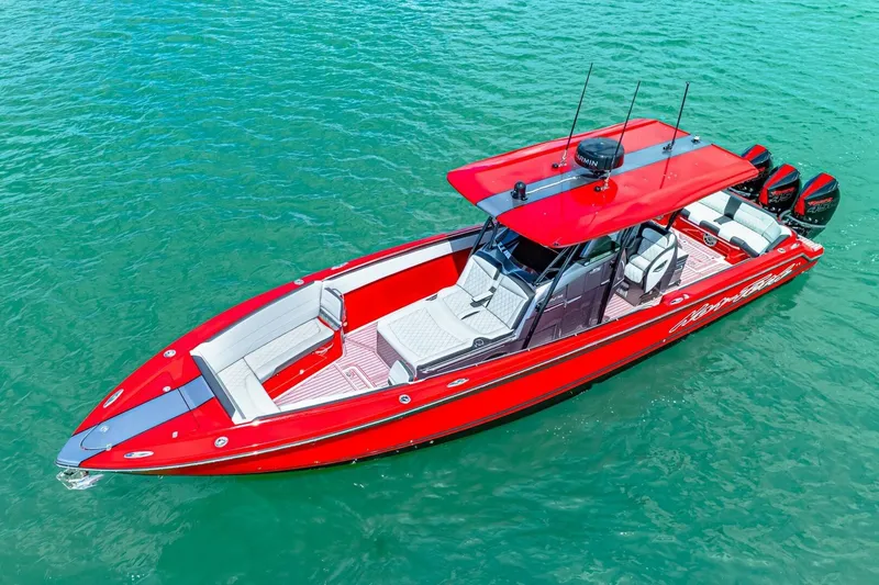 Slide: The Image of 2022 Nor-Tech 390 SS boat in vibrant red on clear blue water. - 63