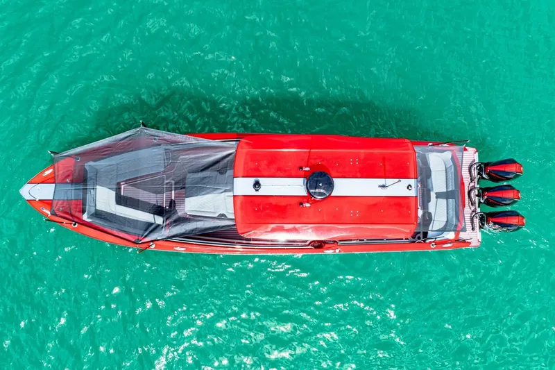 Slide: The Image of Aerial view of 2022 Nor-Tech 390 SS boat on turquoise water. - 64