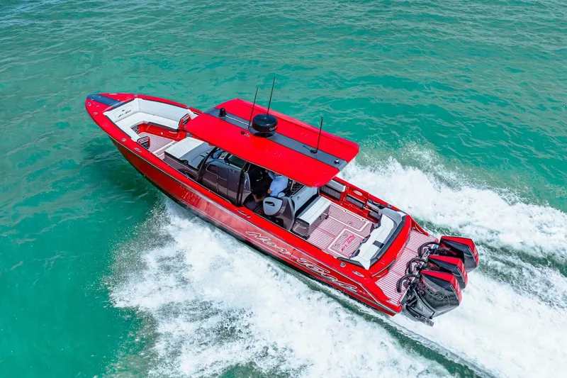 Slide: The Image of Red 2022 Nor-Tech 390 SS speedboat cruising on turquoise water. - 68