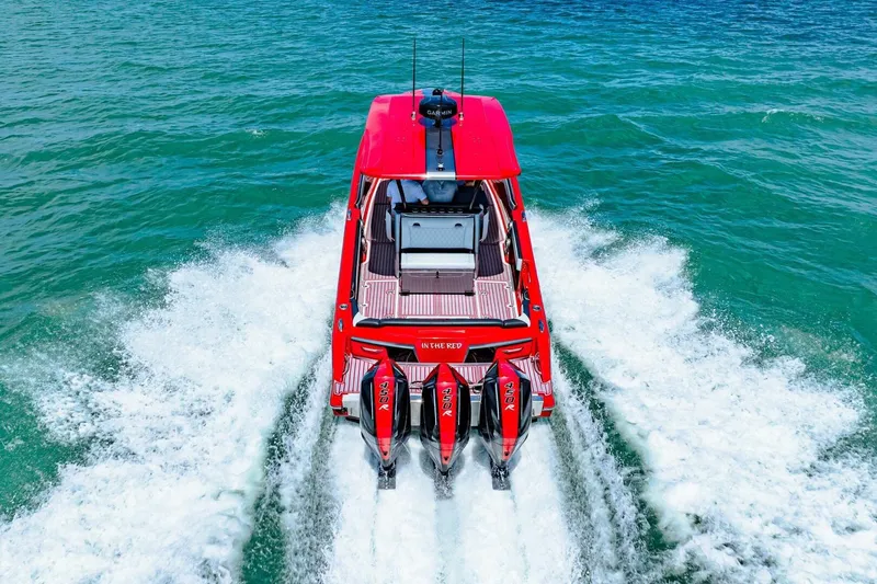 Slide: The Image of Red 2022 Nor-Tech 390 SS boat cruising on clear blue water. - 69