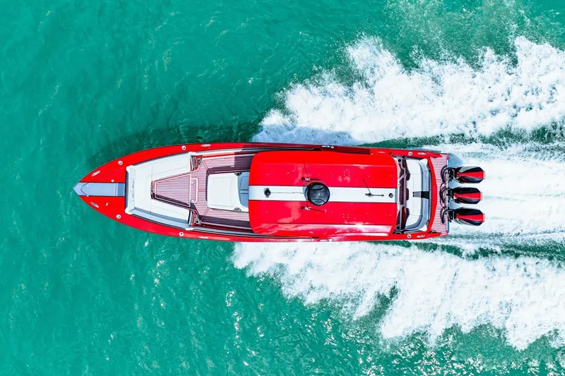Slide: The Image of Aerial view of 2022 Nor-Tech 390 SS speedboat cruising on turquoise water. - 71