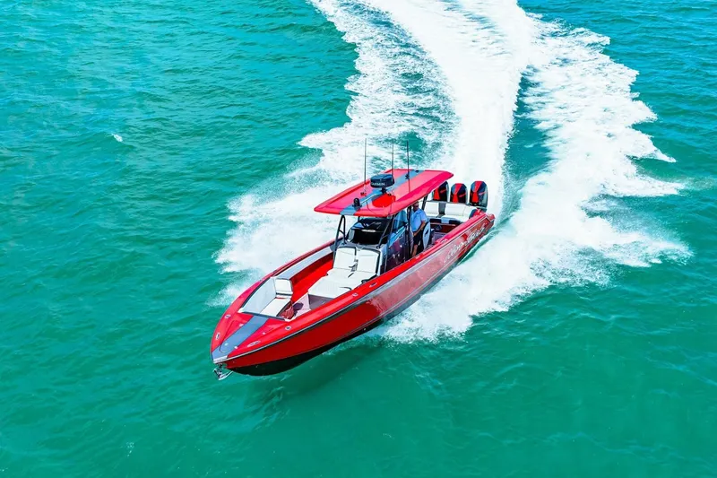 Slide: The Image of Red 2022 Nor-Tech 390 SS speedboat cruising on turquoise water. - 74