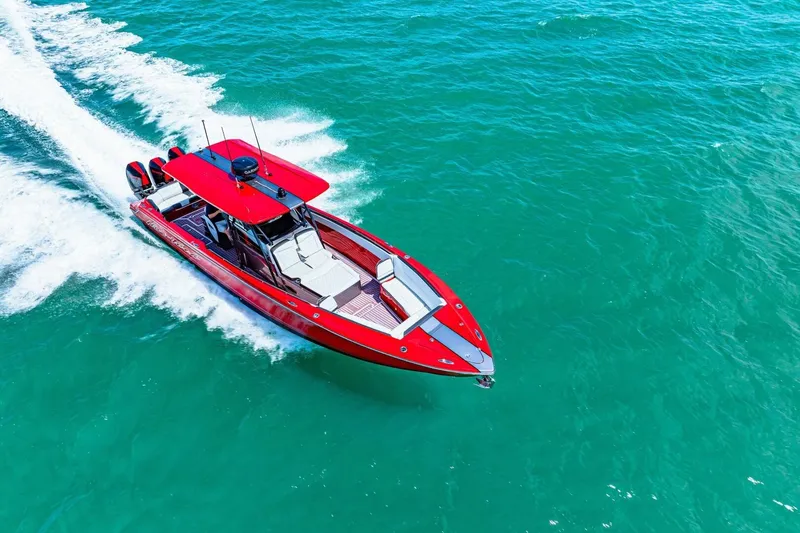Slide: The Image of Red 2022 Nor-Tech 390 SS speedboat cruising on clear blue water. - 75