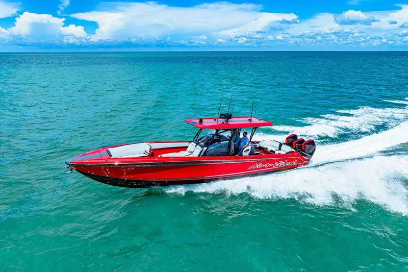 Slide: The Image of 2022 Nor-Tech 390 SS speedboat cruising on turquoise ocean under blue sky. - 79