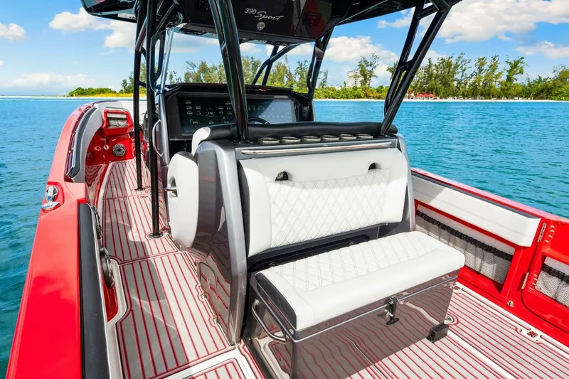 Slide: The Image of 2022 Nor-Tech 390 SS boat interior with red accents on a sunny day. - 8