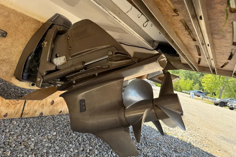 Slide: The Image of 2018 Regal 2800 Bowrider boat propeller and stern drive on gravel surface. - 10