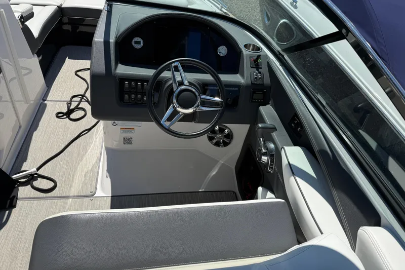 Slide: The Image of 2018 Regal 2800 Bowrider cockpit with steering wheel and control panel. - 7